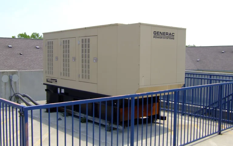 What Size Standby Generator Do I Need for 2,400 Sq Ft? A home standby generator inside a fenced pad beside a building