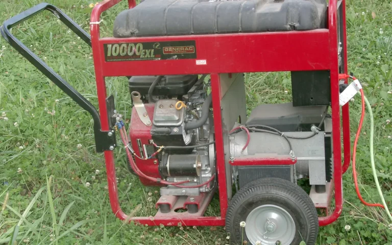 A red open-frame portable generator seen from the side, standing on grass