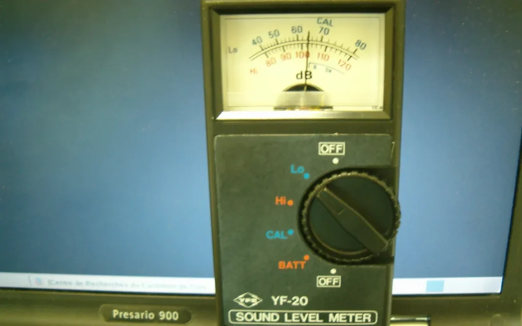 An analog sound level meter with a dial reading decibels