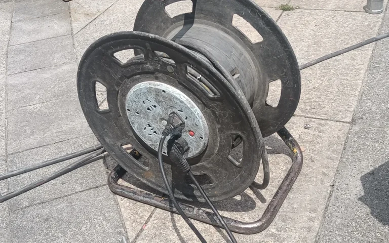 Whole-House Power From a Portable Generator: Sizing It Right An extension cord wound on a metal cable reel