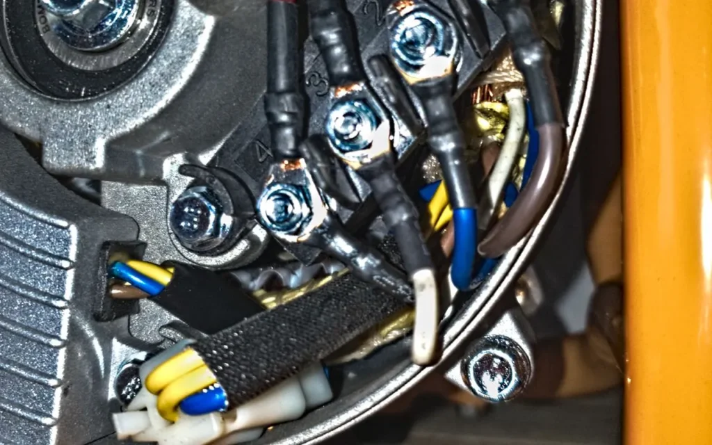 Close-up of the wiring and terminals inside a generator's alternator
