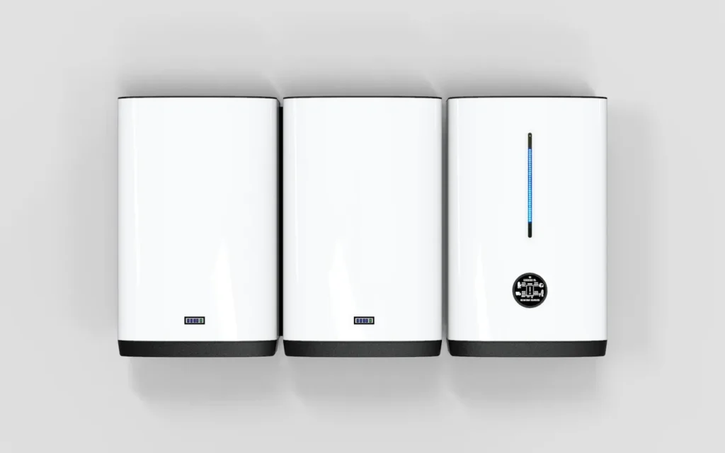 Three white modular home battery units mounted side by side on a wall